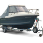 Blue boat on a trailer with 'GREYLAC' branding on a white background